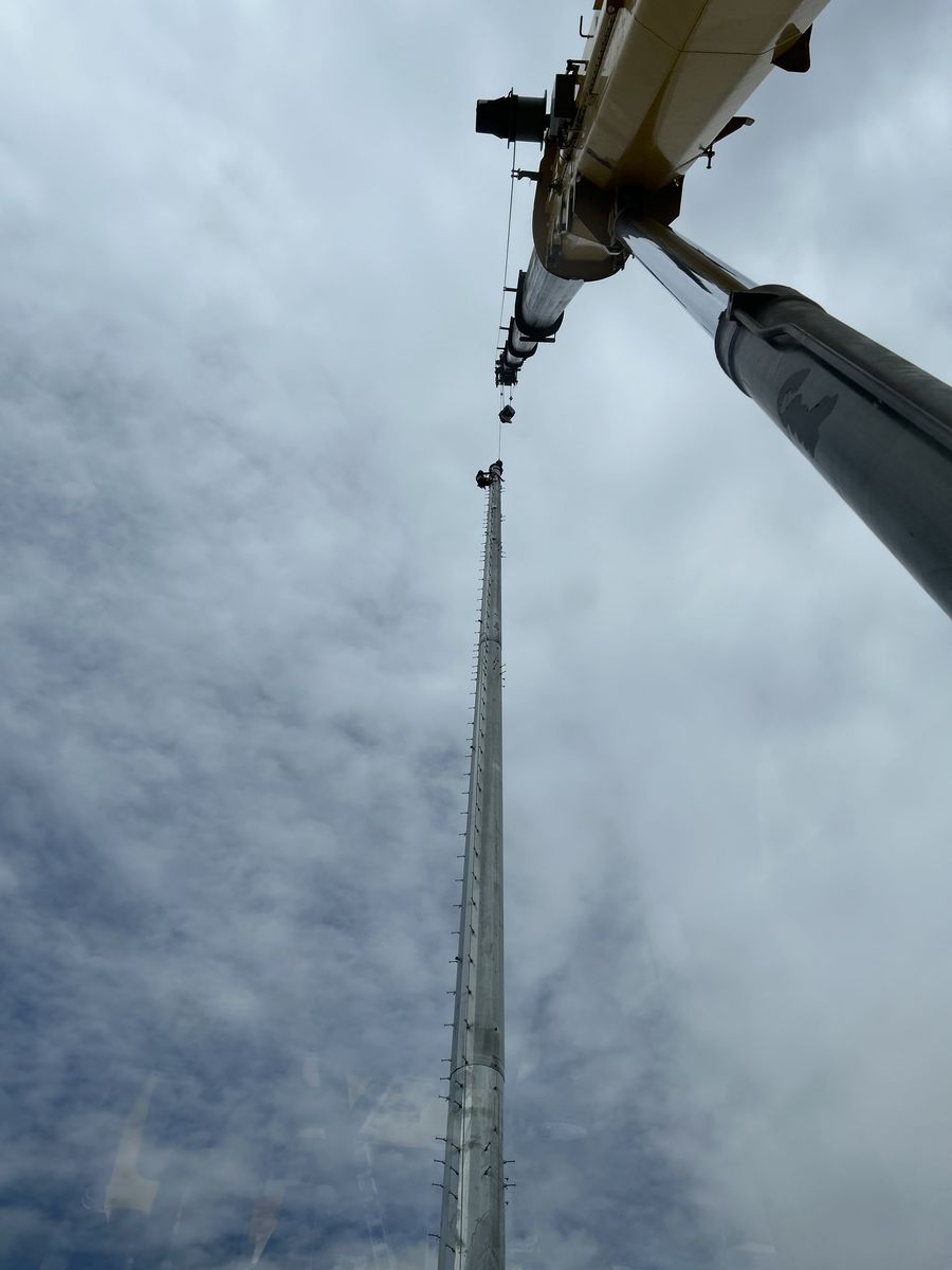 Looking up the extended boom of a Trent Neumann crane during a lift